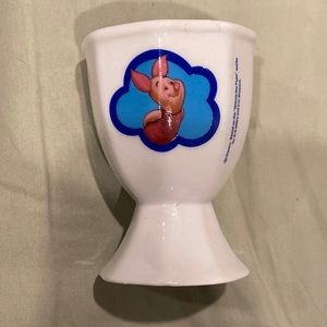 Egg cup with Piglet on one side and Eeyore on the other side.
